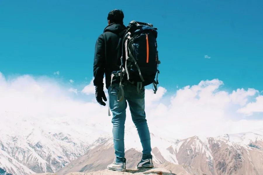 Photo of Man Standing On Top Of Mountain